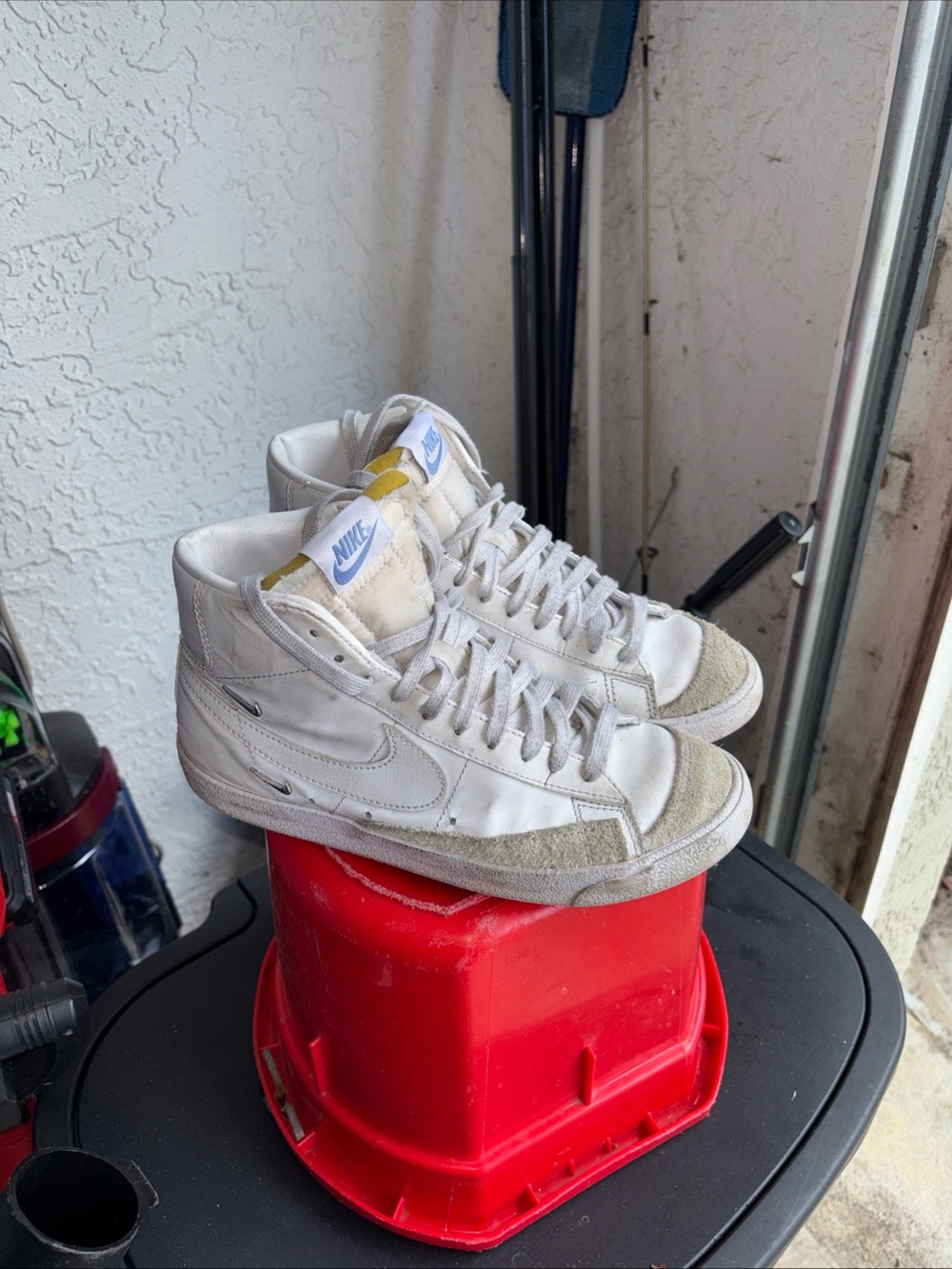 Nike White High-Top Sneakers with Light Gray Suede Accents and Blue Tongue Tag